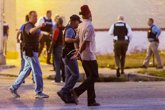 Police arrest a man as protesters gathered after a shooting incident in St. Louis, Missouri August 19, 2015. Police fatally shot a black man they say pointed a gun at them, drawing angry crowds an ...