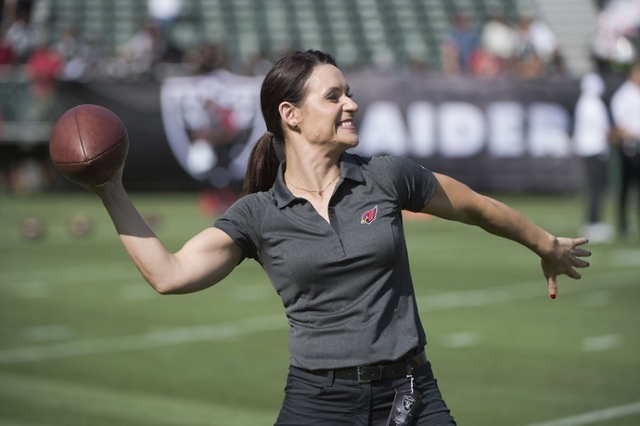 August 30, 2015; Oakland, CA, USA; Arizona Cardinals coaching intern Jen Welter passes the football before a preseason NFL football game against the Oakland Raiders at O.co Coliseum. (Kyle Terada ...