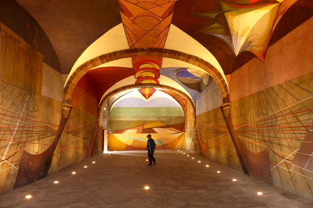 A security guard watches over a cavernous unfinished mural by leading 20th-century Mexican artist David Alfaro Siqueiros at the Bellas Artes (Fine Arts) complex in San Miguel de Allende, Mexico, A ...