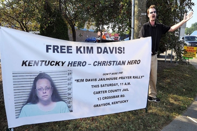 David Jordan, a member of Chirst Fellowship in North Carolina, preaches in support of the prayer rally at the Carter County Detention Center for Rowan County clerk Kim Davis, who remains in contem ...