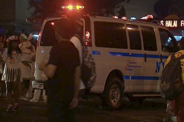 People stand around a police van after a shooting in New York, September 7, 2015, in this handout still image taken from video and provided by NBC 4 New York. Carey Gabay, a top aide to New York G ...
