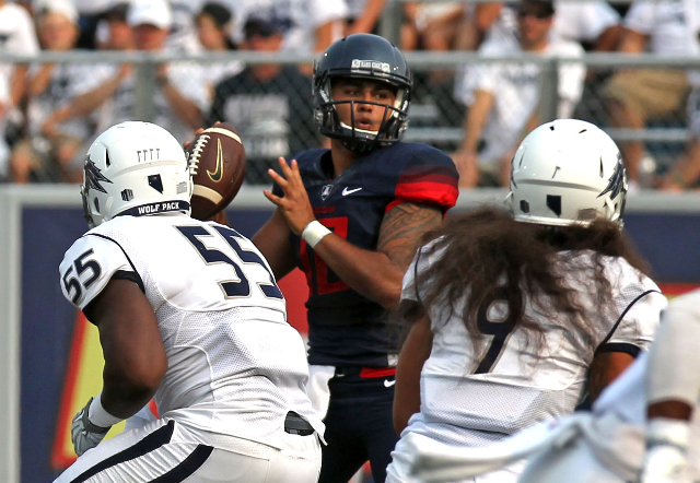 Sep 12, 2015; Reno, NV, USA; Arizona Wildcats quarterback Anu Solomon (12) sets to throw in the first quarter of their NCAA football game with the Nevada Wolf Pack at MacKay Stadium. Mandatory Cre ...