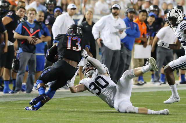 Sep 12, 2015; Provo, UT, USA; Boise State Broncos running back Jeremy McNichols (13) runs over Brigham Young Cougars defensive back Michael Wadsworth (30) during the first quarter at Lavell Edward ...