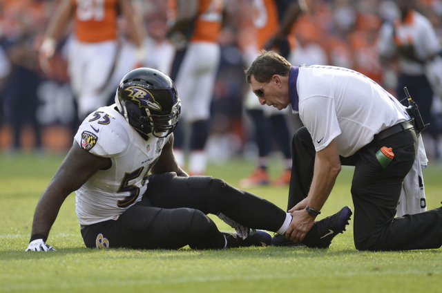 Sep 13, 2015; Denver, CO, USA; Baltimore Ravens outside linebacker Terrell Suggs (55) sits on the ground after an injury to his left lower leg in the fourth quarter against the Denver Broncos at S ...
