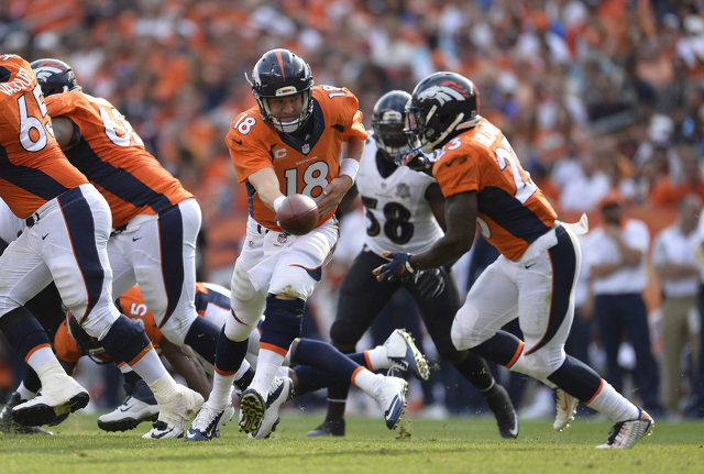 Sep 13, 2015; Denver, CO, USA; Denver Broncos quarterback Peyton Manning (18) prepares to hand off to running back Ronnie Hillman (23) in the fourth quarter against the Baltimore Ravens at Sports  ...