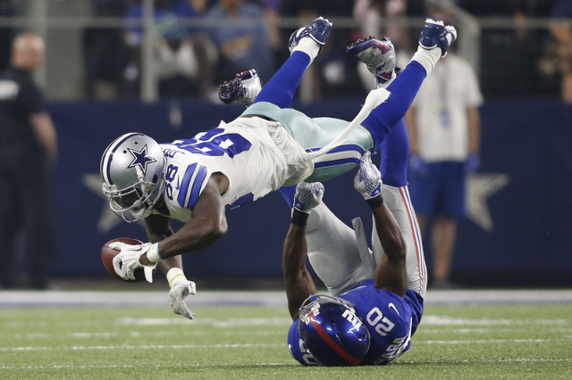 Sep 13, 2015; Arlington, TX, USA; Dallas Cowboys wide receiver Dez Bryant (88) catches the ball as New York Giants cornerback Prince Amukamara (20) tackles at AT&T Stadium. The Cowboys won 27- ...