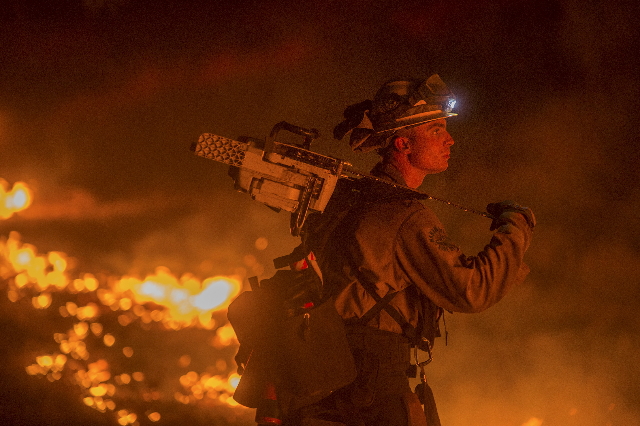 Firefighter Jesse Kaplanis battles the Valley Fire in Lower Lake, California September 13, 2015.  (Noah Berger/Reuters)