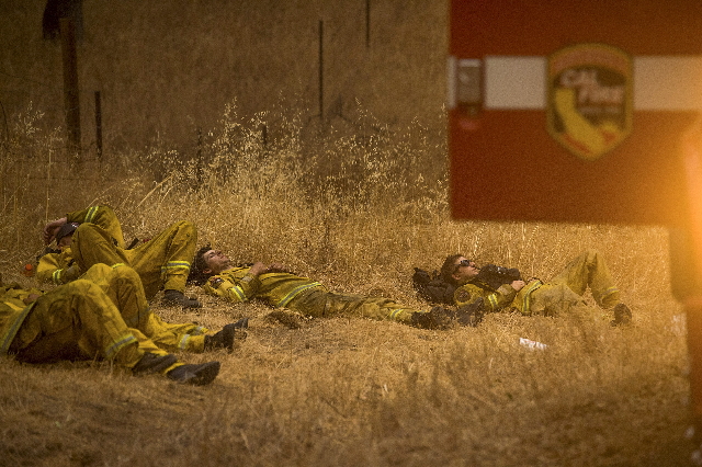 Cal Fire Santa Clara firefighters rest after battling the Valley Fire in Middletown, California September 13, 2015. (Noah Berger/Reuters)