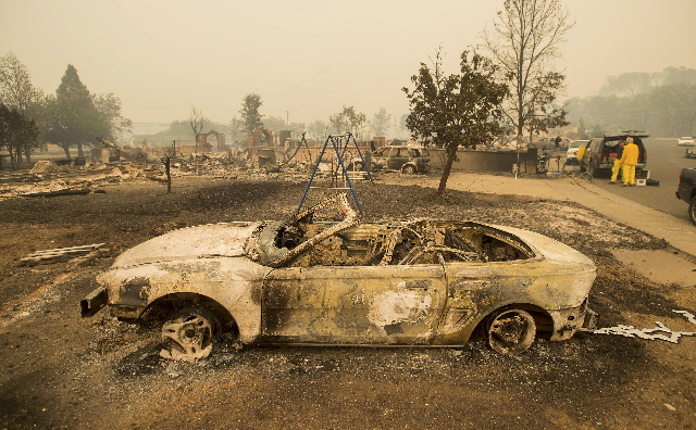 Burned out remains of a vehicle and swing set scorched by the Valley Fire line Jefferson St. in Middletown, California September 13, 2015.  (Noah Berger/Reuters)