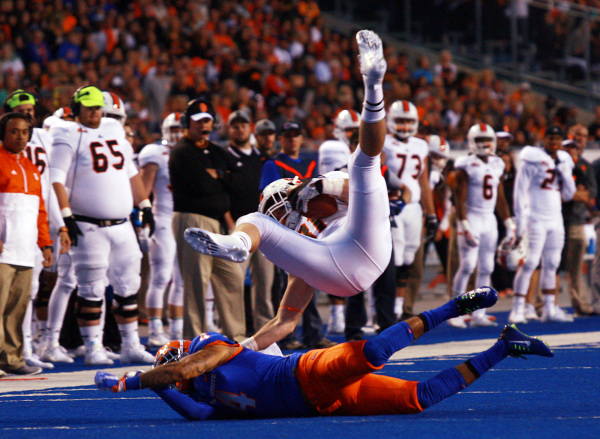 Sep 18, 2015; Boise, ID, USA; Idaho State Bengals running back Xavier Finney (31) gets upended by Boise State Broncos safety Darian Thompson (4) at Albertsons Stadium. Mandatory Credit: Brian Losn ...