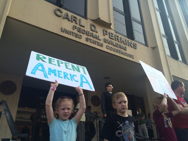 Supporters hold signs outside federal court in Ashland, Kentucky, on Thursday, Sept. 3, 2015. Rowan County Clerk Kim Davis was held in contempt of court after she refused a Supreme Court ruling sa ...