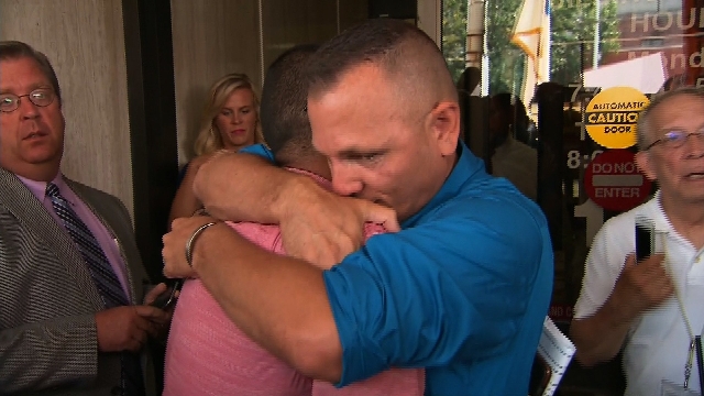 Jonathan and Dwayne Beebe-Franqui of Pensacola, Florida, embrace following a judge ordering Rowan County, Kentucky, Clerk Kim Davis into custody after she failed to issue same-sex marriage license ...