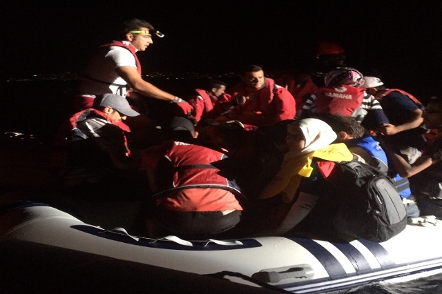 Migrants and refugees stranded aboard an overloaded rubber dinghy clamber aboard a Turkish search and rescue boat. Under the cover of darkness September 6, 2015, on cold, unpredictable seas, they ...