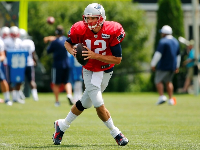 Aug 6, 2015; Foxborough, MA, USA; New England Patriots quarterback Tom Brady (12) scrambles during training camp at Gillette Stadium. (Winslow Townson/USA Today Sports)