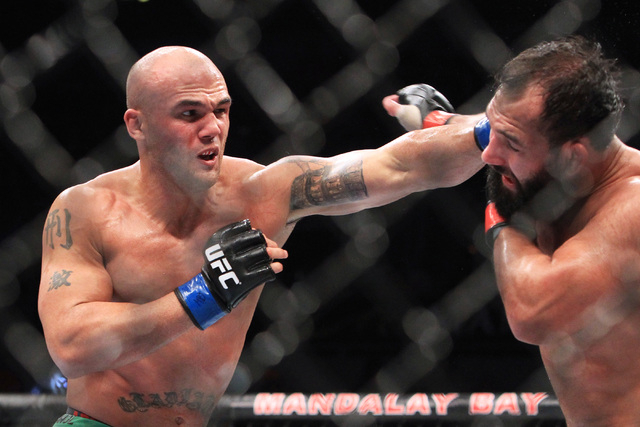 Robbie Lawler hits Johny Hendricks with a left during their fight at UFC 181 Saturday, Dec. 6, 2014 at the Mandalay Bay Events Center. (Sam Morris/Las Vegas Review-Journal)