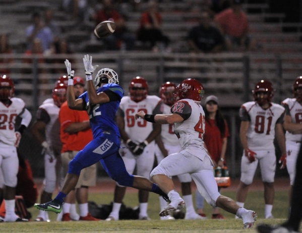 Green Valley wide receiver Brayon Williams catches a pass as Arbor View safety Andrew Wagner ...