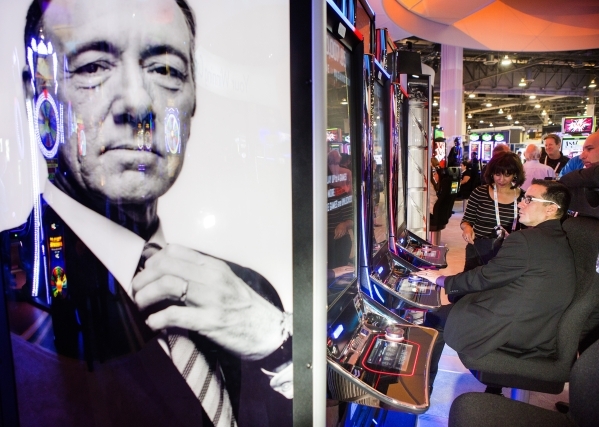 An image of actor Kevin Spacey is seen in front of a row of  House of Cards gaming machines in the International Game Technology booth at the Global Gaming Expo in the Sands Expo and Convention Ce ...