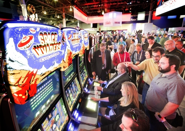 People play a Space Invaders skill-based gaming machine in the Scientific Games booth at the Global Gaming Expo in the Sands Expo and Convention Center on Wednesday, Sept. 30, 2015. (Jeff Scheid/  ...