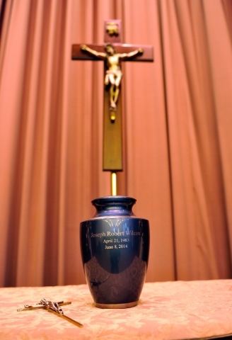 An urn containing the remains of Joseph Wilcox is displayed before a memorial service for him at Palm Downtown Mortuary and Cemetery on Sunday, June 22, 2014. Wilcox, 31, was killed trying to stop ...
