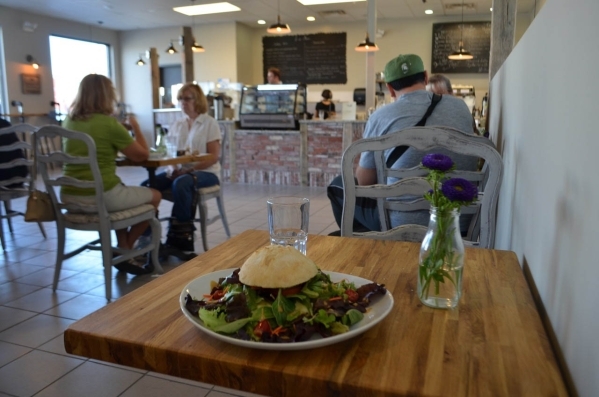 The EST (East) Sandwich at Rosallie Le French Cafe, 6090 S. Rainbow Blvd., is shown with Brie and tomato toasted with olive oil and garlic on a French bread roll. It is served on a bed of mixed gr ...