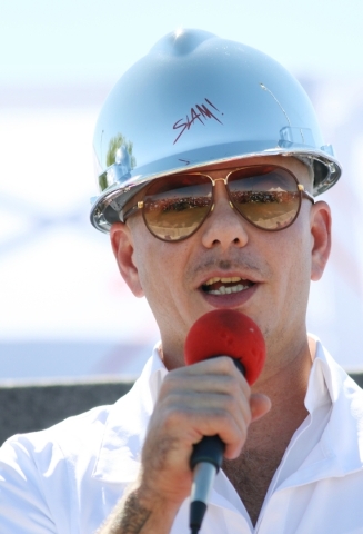 Rapper Pitbull speaks during a groundbreaking ceremony as an honored guest for Sports Leadership and Management (SLAM!) charter middle and high school Friday, Oct. 2, 2015, in Henderson. SLAM! is  ...