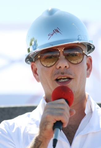 Rapper Pitbull speaks during a groundbreaking ceremony as an honored guest for Sports Leadership and Management (SLAM!) charter middle and high school Friday, Oct. 2, 2015, in Henderson. SLAM! is ...