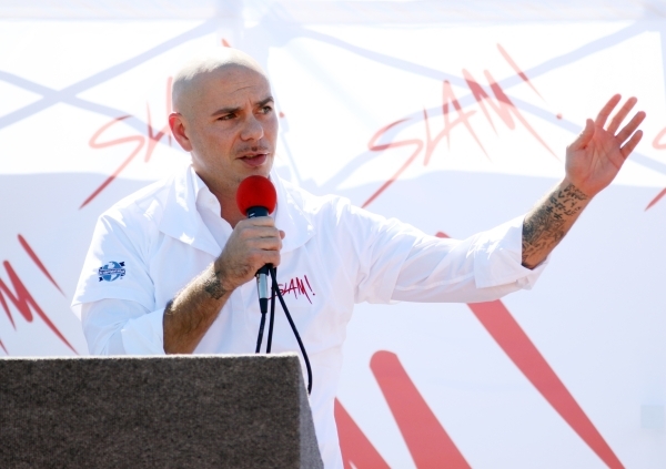 Rapper Pitbull speaks during a groundbreaking ceremony for Sports Leadership and Management (SLAM!) charter middle and high school Friday, Oct. 2, 2015, near the Russell Road Recreation Complex in ...