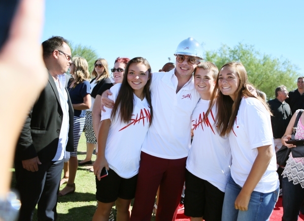 Rapper Pitbull, third from right, stands for a personal photo with students Katie Ballou, right; Nick Ballou, second from right; and Taylor Santos, fourth from right, during a groundbreaking cerem ...