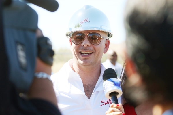 Rapper Pitbull speaks to the news media during a groundbreaking ceremony for Sports Leadership and Management (SLAM!) charter middle and high school Friday, Oct. 2, 2015, in Henderson. SLAM! is sl ...