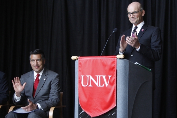 Gov. Brian Sandoval, left, is introduced by Thomas Piechota, vice president for research and economic development at UNLV, during a press conference at the UNLV Science and Engineering Building in ...