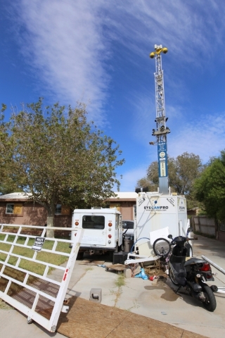 A portable tower of surveillance equipment towers over the home of Rick Van Thiel on Thursday, Oct. 8, 2015 in Las Vegas, where he allegedly performed medical procedures including abortions and ca ...