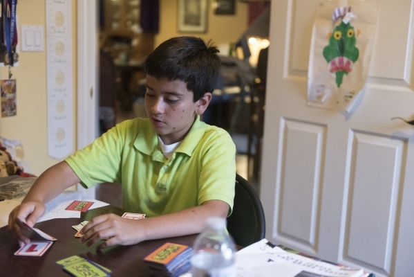 Eleven-year-old J.C. Hill works through an exercise during his therapy sessionwith Roo Abdel-Al, a supervising consultant at The Lovass Center, at Hill‘s residence in Las Vegas Wednesday, Oc ...
