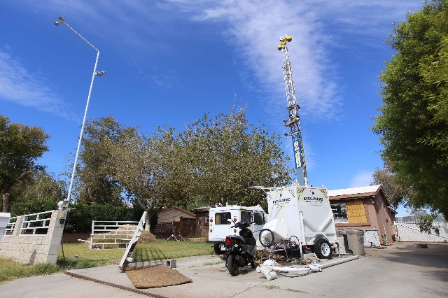 A portable tower of surveillance equipment towers over the home of Rick Van Thiel on Thursday, Oct. 8, 2015 in Las Vegas, where he allegedly performed medical procedures like abortions and cancer  ...