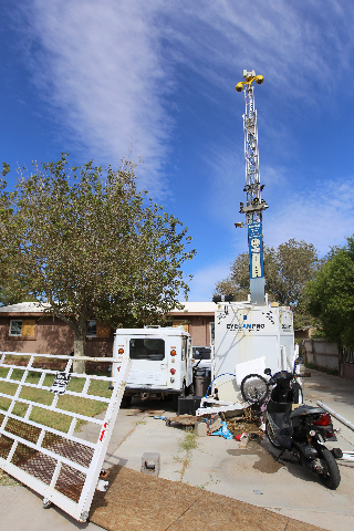 A portable tower of surveillance equipment towers over the home of Rick Van Thiel on Thursday, Oct. 8, 2015 in Las Vegas, where he allegedly performed medical procedures like abortions and cancer  ...