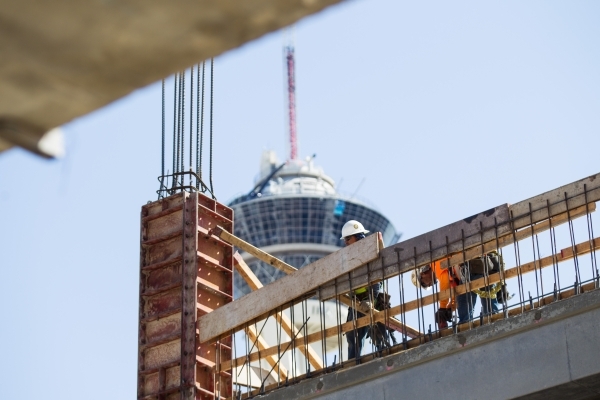 Construction workers, with the Stratosphere hotel-casino in the background, make progress on the Lucky Dragon hotel-casino in Las Vegas on Friday, Sept. 11, 2015. Chase Stevens/Las Vegas Review-Jo ...