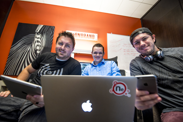 Kenny Eliason, from left, Spencer Guier, and Mychal Calderon pose for a photo while holding their Apple devices at the NeONBRAND office in Las Vegas on Wednesday, Oct. 28, 2015. Joshua Dahl/Las Ve ...
