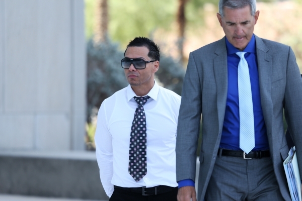 Ernesto Joshua Ramos, left, walks to Lloyd George Federal Courthouse in Las Vegas with his attorney Gabriel Grasso to plead guilty to an extortion charge Tuesday, Nov. 3, 2015. Erik Verduzco/Las V ...