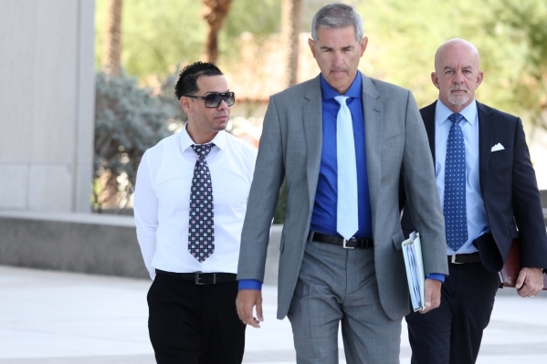 Ernesto Joshua Ramos, left, walks to Lloyd George Federal Courthouse in Las Vegas with his attorney Gabriel Grasso, center, to plead guilty to an extortion charge Tuesday, Nov. 3, 2015. Erik Verdu ...