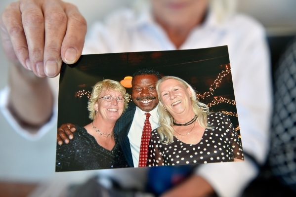 A photograph is displayed by Beth Hultgren of herself, right, and her long time boyfriend and victim, Michael Boldon, center, before Ammar Harris‘s penalty hearing at the Regional Justice Ce ...