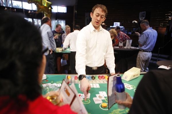 Chris Madden deals a game of cards during an event at Red Rock casino-hotel where top Station Casinos players were invited to play five new table games created by UNLV students, Sunday, Nov. 1, 20 ...