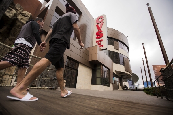 Two men walk pass the CVS store at Treasure Island on Tuesday, Nov. 10, 2015. The Treasure Island announced that  Marvel Comics will open a two story store above CVS Pharmacy based on the Advenger ...