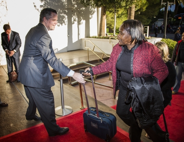 Jim Murren, chairman and CEO of MGM Resorts International, helps a guest with her bag during the "Salute the Troops" event at the The Mirage on Friday, Nov. 13, 2015. MGM Resorts Interna ...