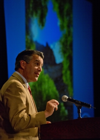 Nevada Gov. Brian Sandoval speaks while a slide show of images he collected in Nevada‘s 23 state parks plays in the background at the Governor‘s Global Tourism Summit at the Hilton Lak ...