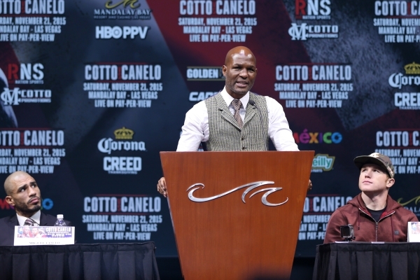 Former boxer Bernard Hopkins, center, speaks during the final press conference for Miguel Cotto, left, and Saul "Canelo" Alvarez at Mandalay Bay casino-hotel in Las Vegas Wednesday, Nov. ...
