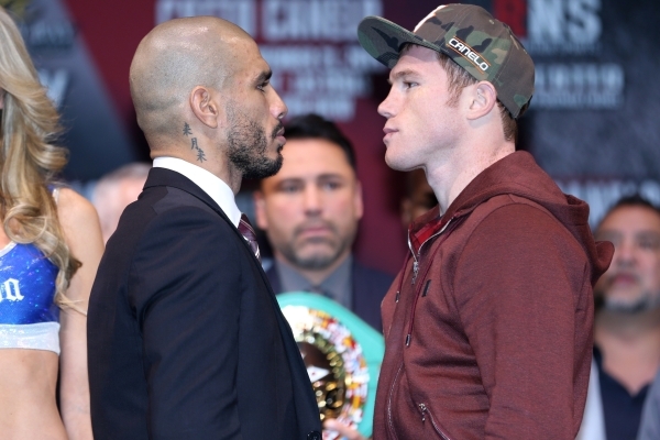 Miguel Cotto, left, and Canelo Alvarez face off during the final press conference at Mandalay Bay casino-hotel in Las Vegas Wednesday, Nob. 18, 2015. Canelo and Cotto will fight Saturday for the W ...