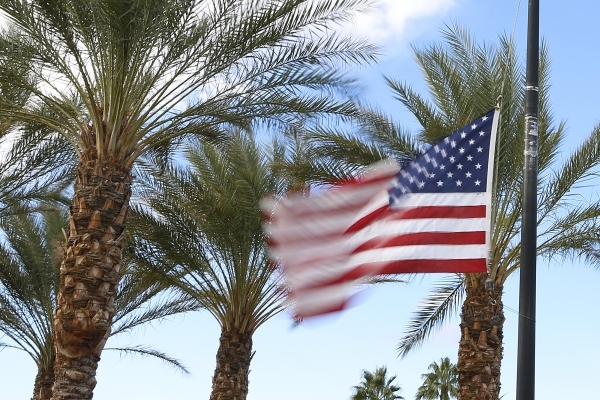 A wind-blown U.S. flag flies at half-staff to honor victims of the Paris attack is seen on Monday, Nov. 16, 2015, outside the Luxury Residences at Spanish Trail on Tropicana Avenue. (Bizuayehu Tes ...