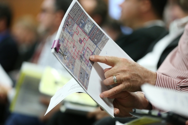 A man looks at a map during a Bureau of Land Management land auction to sell 33 parcels of public land at the at North Las Vegas City Hall Tuesday, Nov. 17, 2015 in North Las Vegas. Erik Verduzco/ ...
