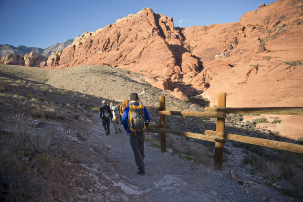 Hikers head down a trail inside the scenic loop of the Red Rock Canyon National Conservation Area on Monday, Nov. 16 2015. Red Rock is celebrating its 25th anniversary as a national conservation a ...