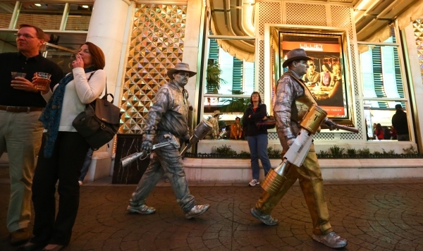 Street performers move to a new location zone on the Fremont Street Experience in downtown Las Vegas on Tuesday, Nov. 17, 2015. Tuesday was the first day of the city‘s new ordinance requirin ...