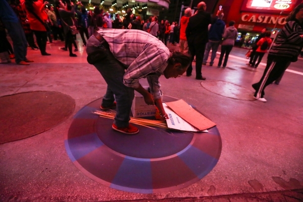 A street performer arrives at a new location zone on the Fremont Street Experience in downtown Las Vegas on Tuesday, Nov. 17, 2015. Tuesday was the first day of the city‘s new ordinance requ ...